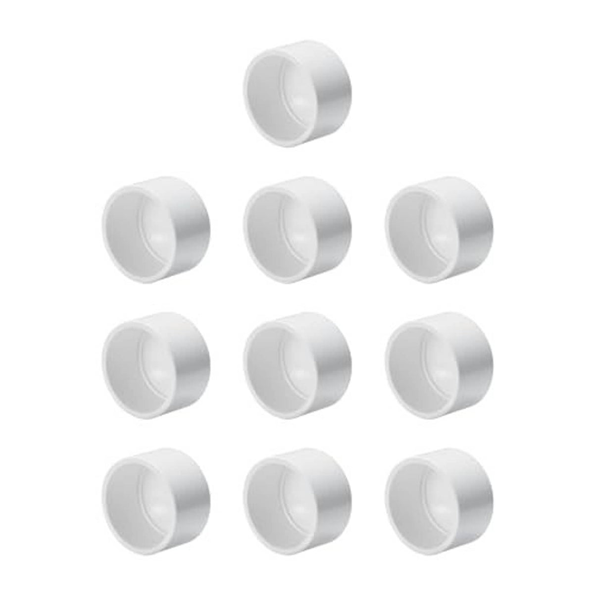 White PVC schedule 40 end caps, multiple pieces arranged with round openings