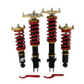 Adjustable coilover struts with red springs, black shocks, gold top mounts, and red tool