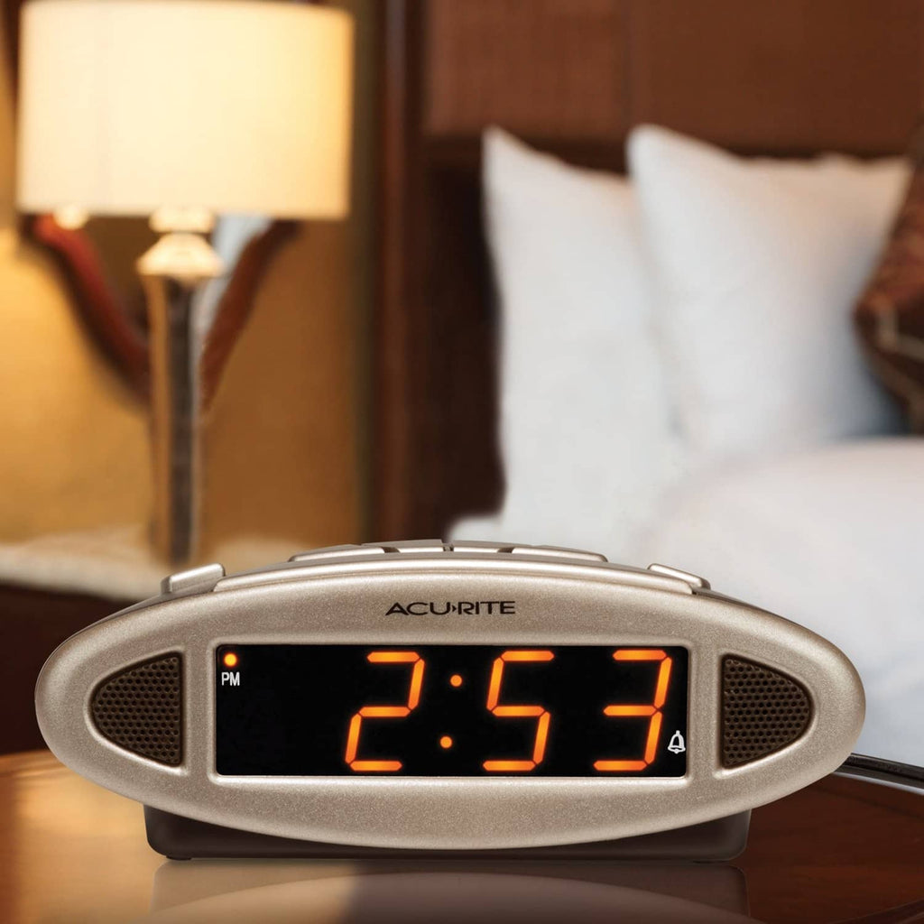 Digital alarm clock with orange LED time display and oval speaker grilles