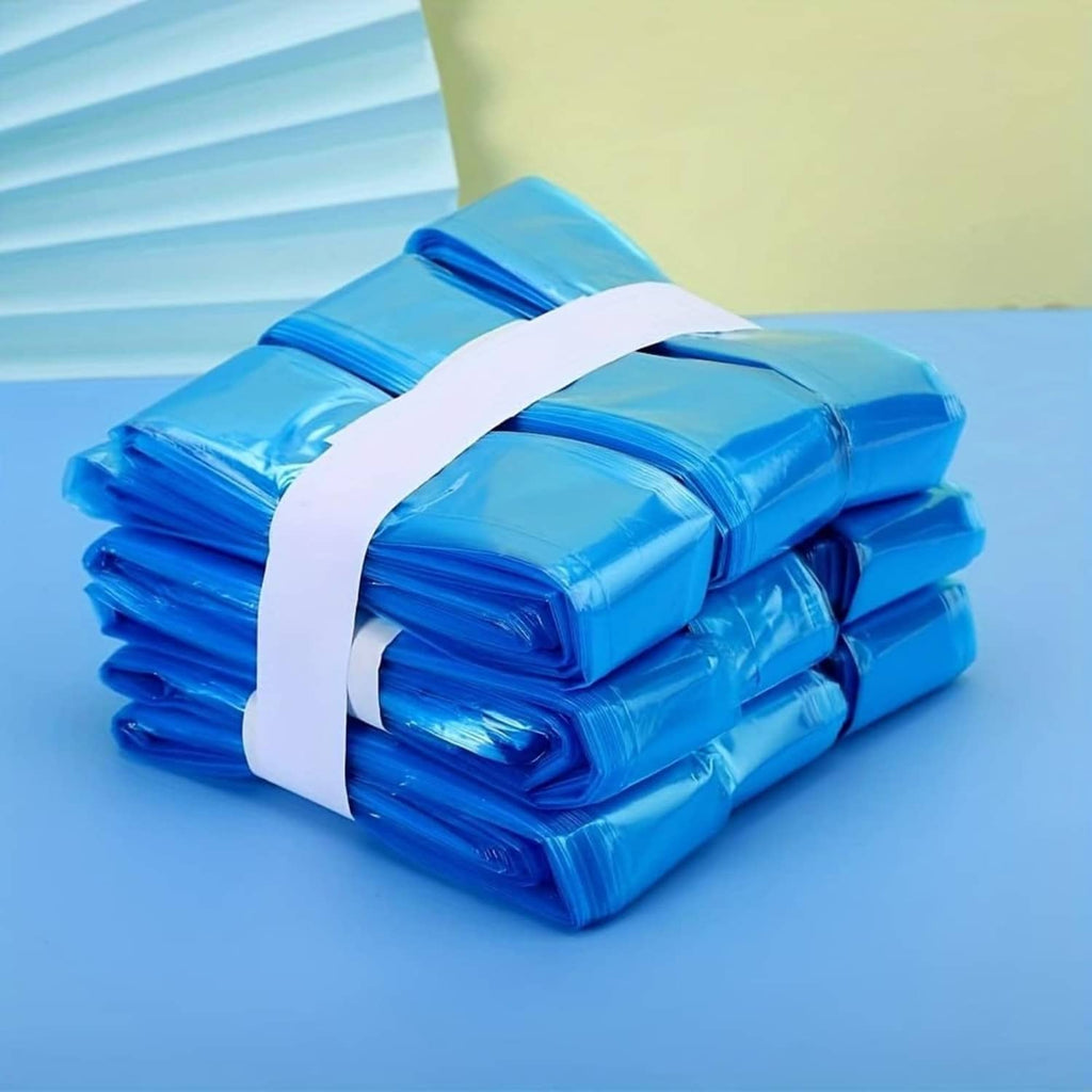 Rolled blue cat litter refill bags stacked with a white tie strap across the bundle.