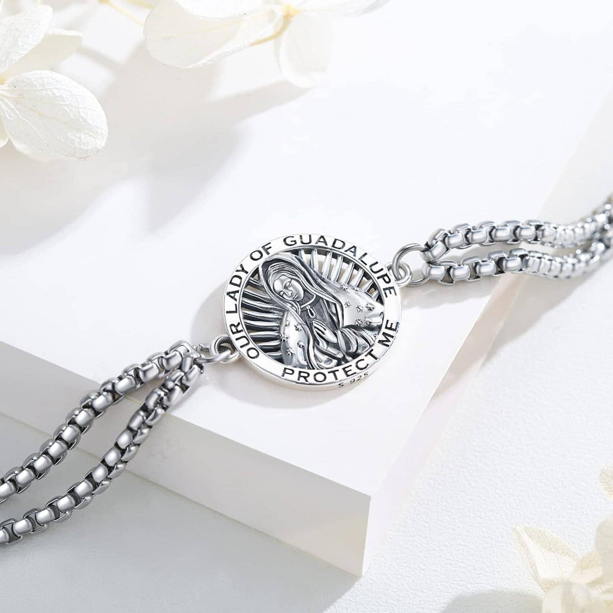 Close-up silver-tone bracelet with circular Our Lady of Guadalupe medallion