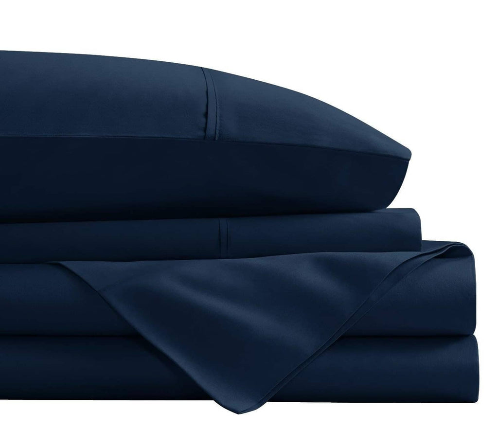 Navy brushed microfiber sheet stack detail with smooth seams and soft drape.