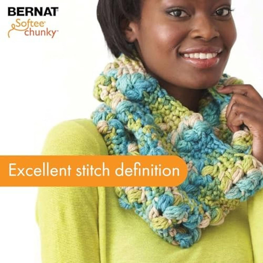 Multicolor chunky knit scarf with textured stitches, worn around the neck.