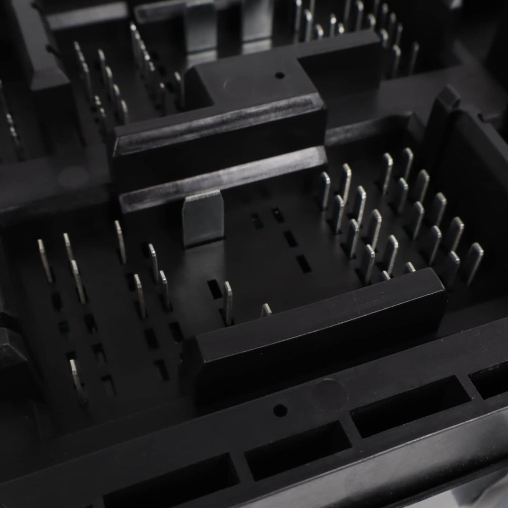 Automotive fuse relay junction block with molded black terminals and fuse slots