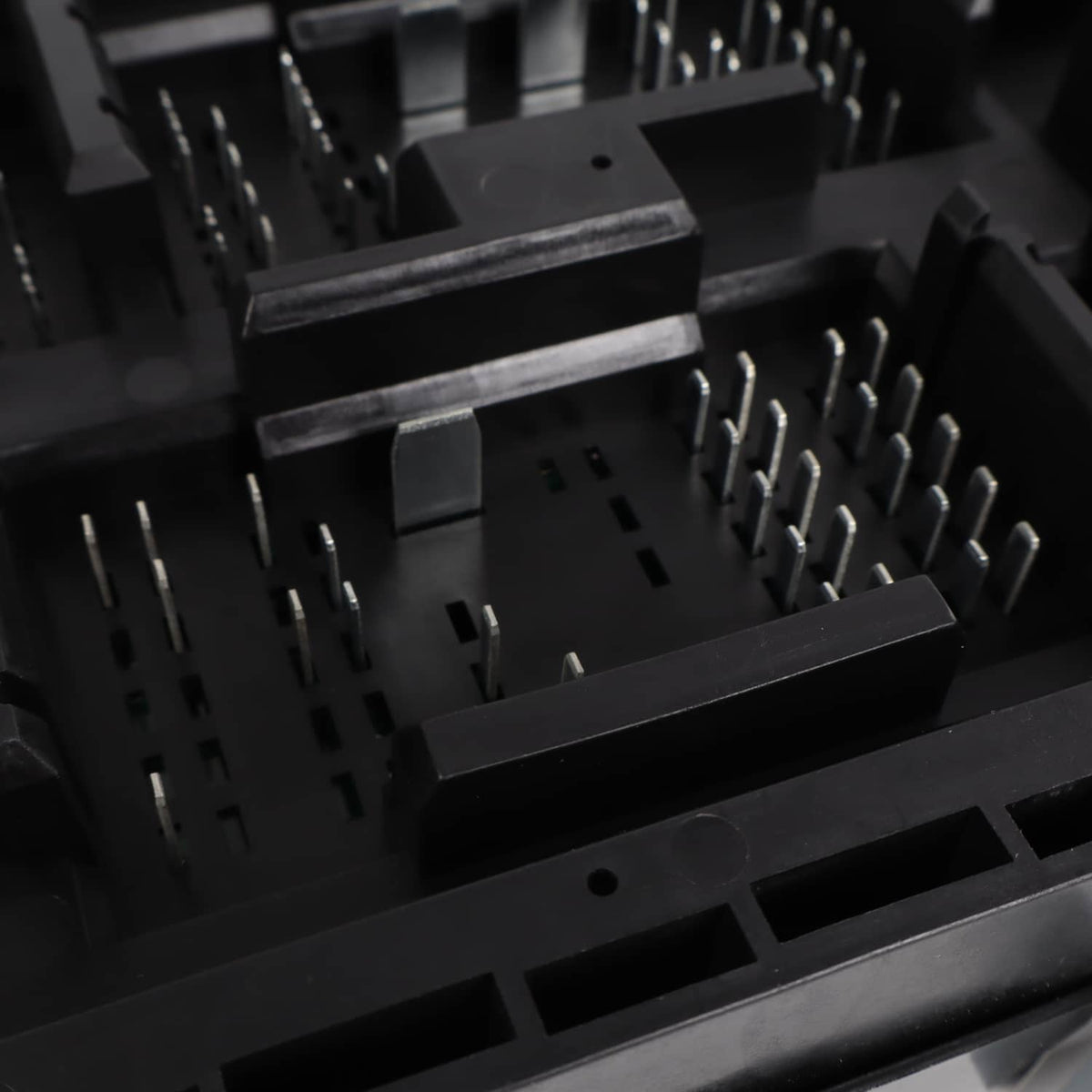 Automotive fuse relay junction block with molded black terminals and fuse slots