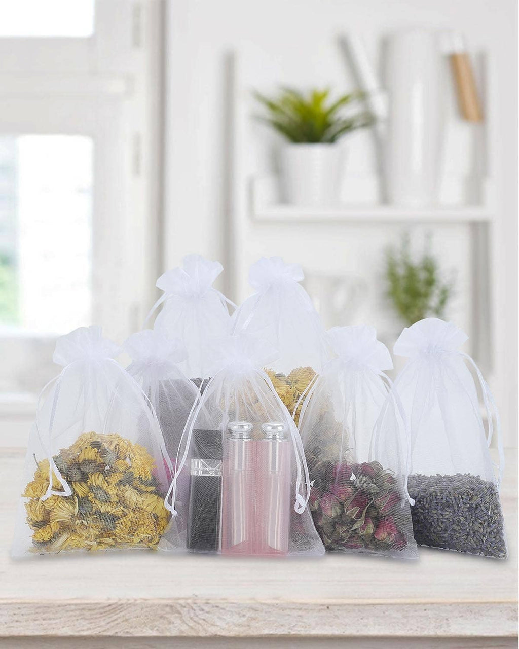 White mesh drawstring bags filled with assorted candies on a shelf