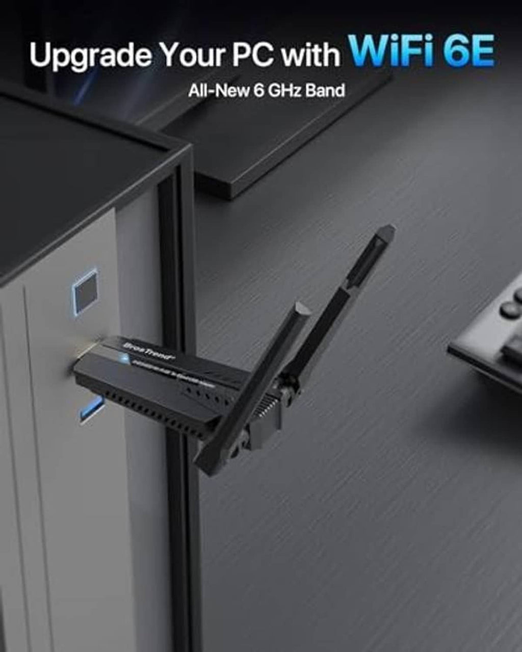 WiFi 6E USB adapter plugged into a desktop USB port with two antennas upright