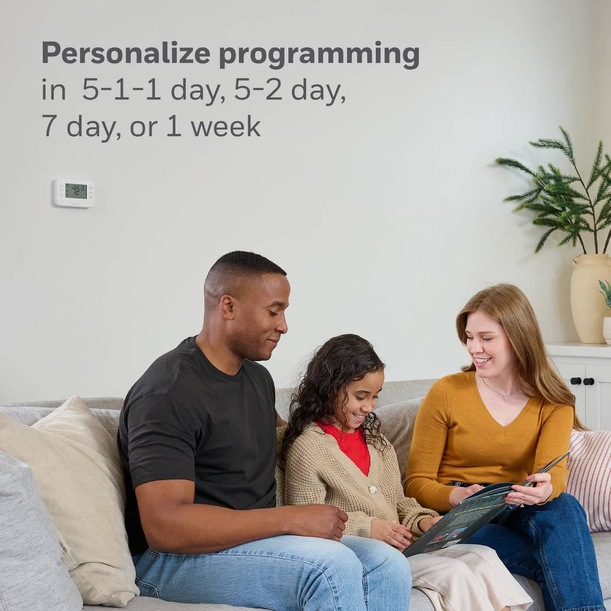 Family relaxing while using a smartphone app to control a smart thermostat