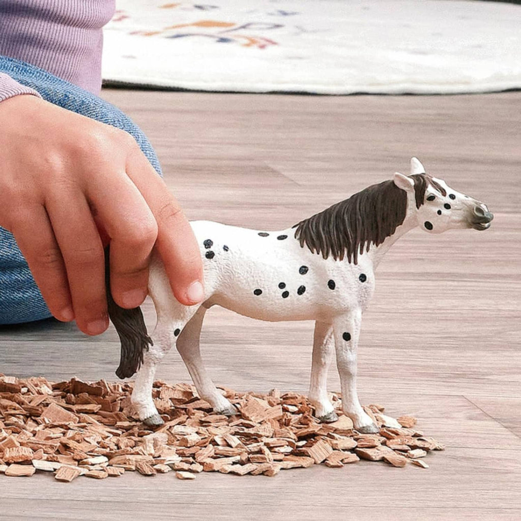 Leopard-spotted horse toy figure with black mane and tail, standing on all four legs.