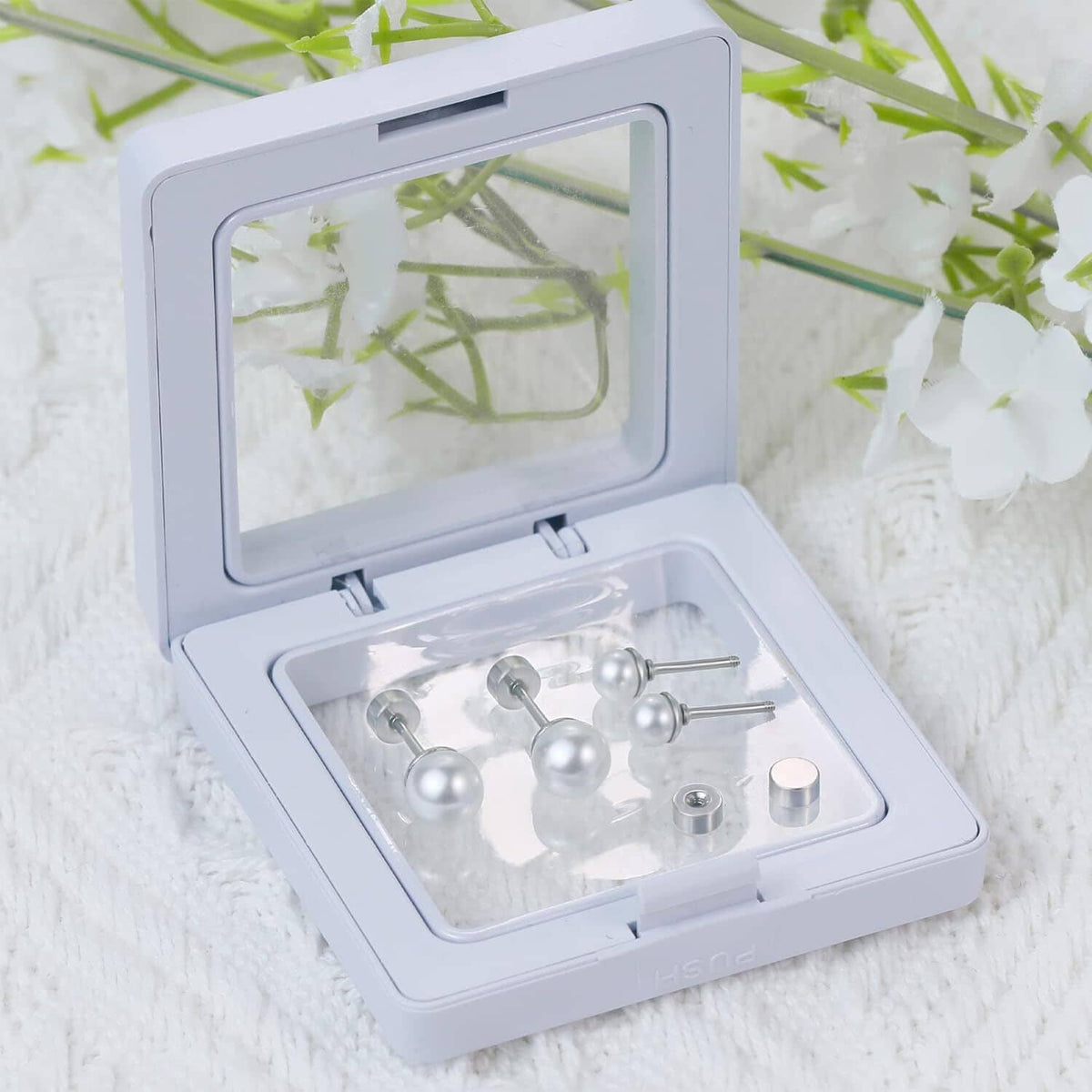 Pearl titanium stud earrings in storage box, with screw-back posts and pearls