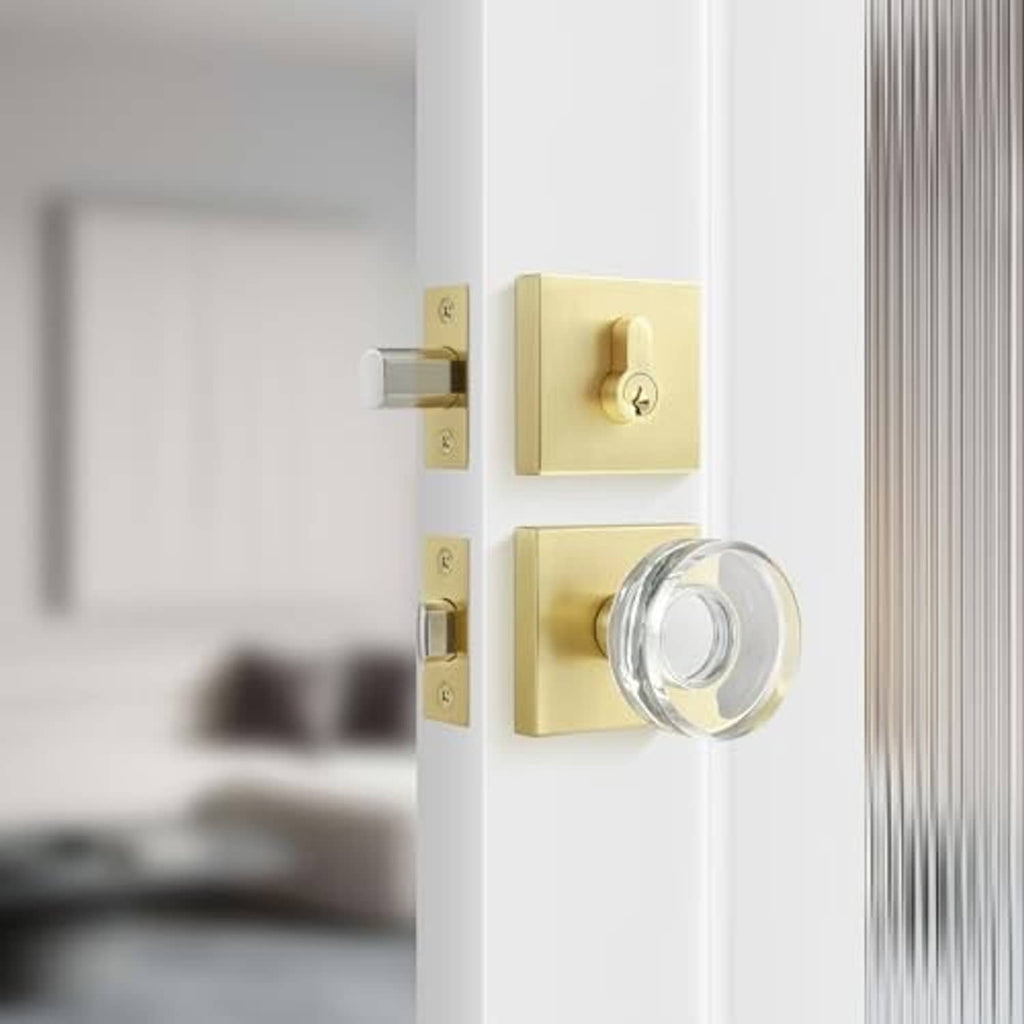 Deadbolt lock set with satin brass plates and chrome knob on a white door