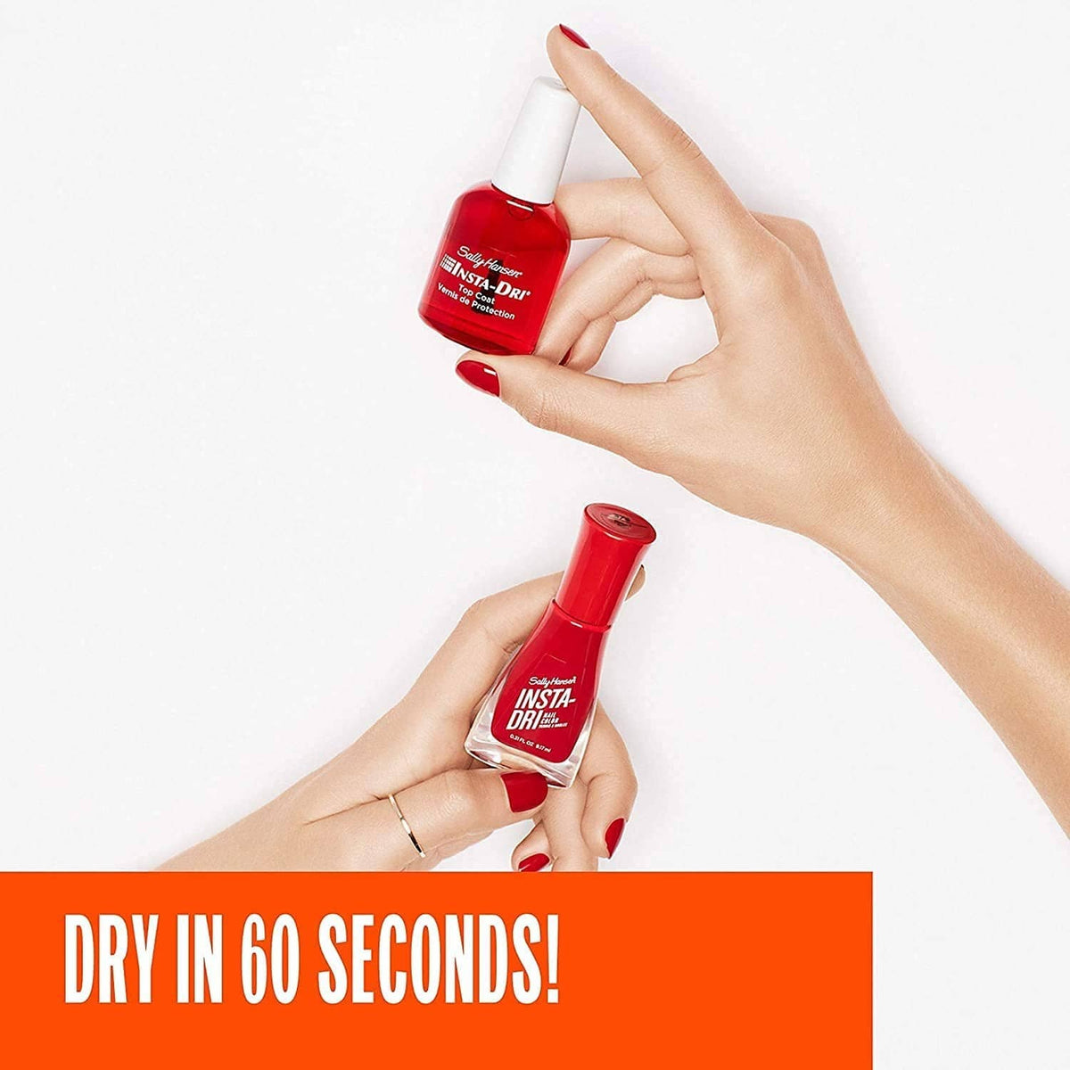 Two clear nail top coat bottles held in hands with red painted nails