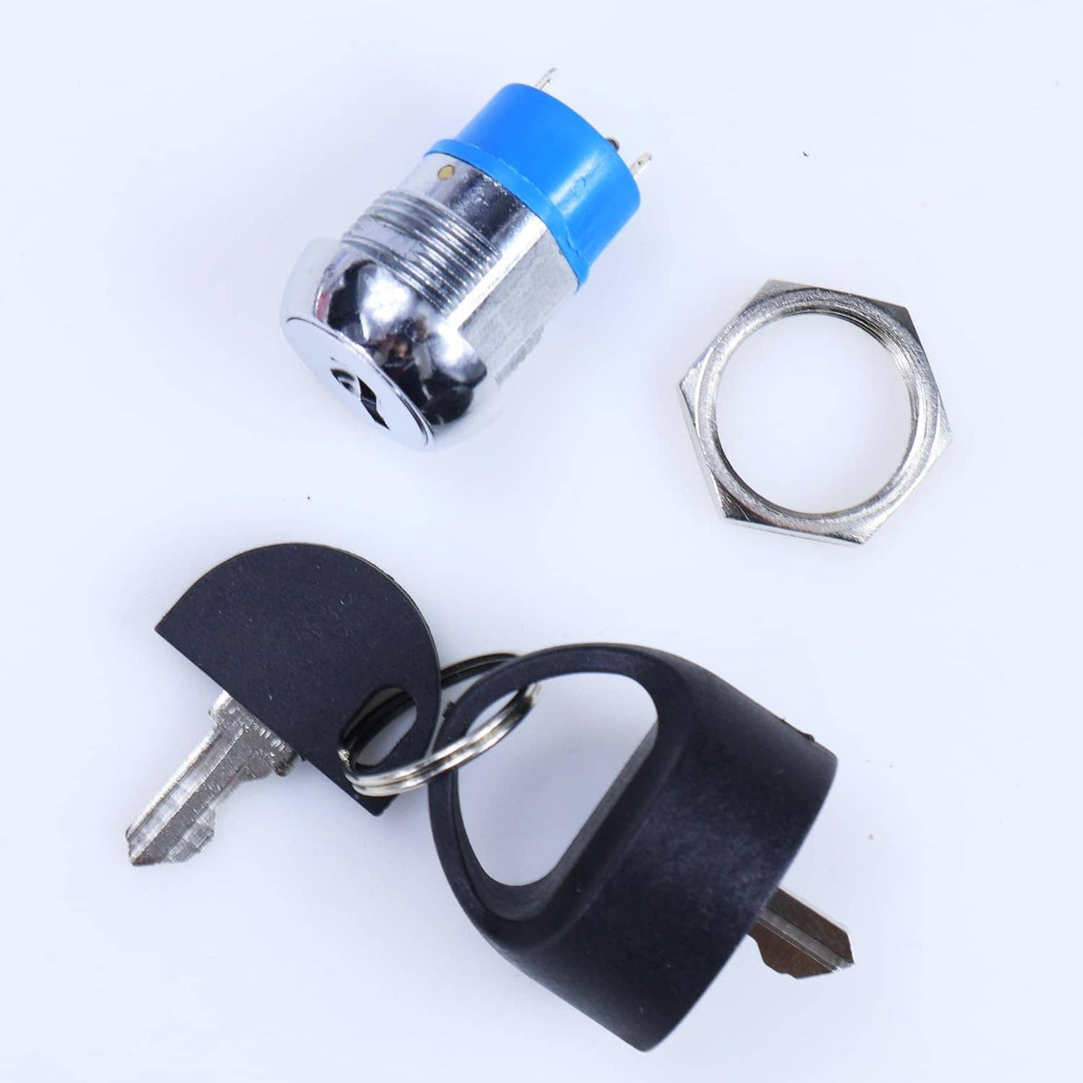 Ignition starter switch with blue push-button cap, metal keys, and mounting hardware