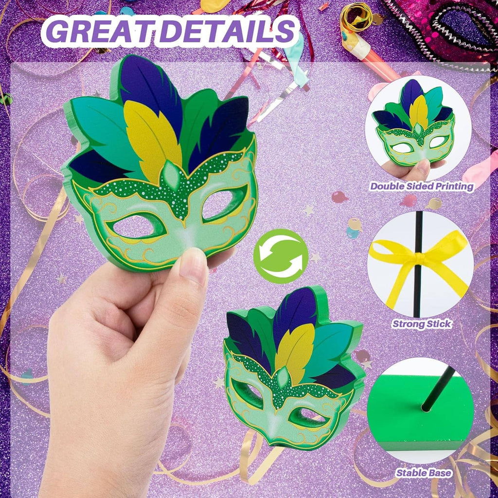 Wooden Mardi Gras centerpiece held by hand: green and purple masks on sticks with ribbons