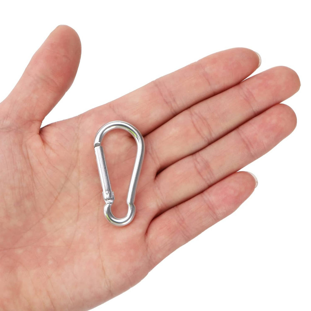 Mini aluminum spring clip carabiner held in palm, silver metal latch