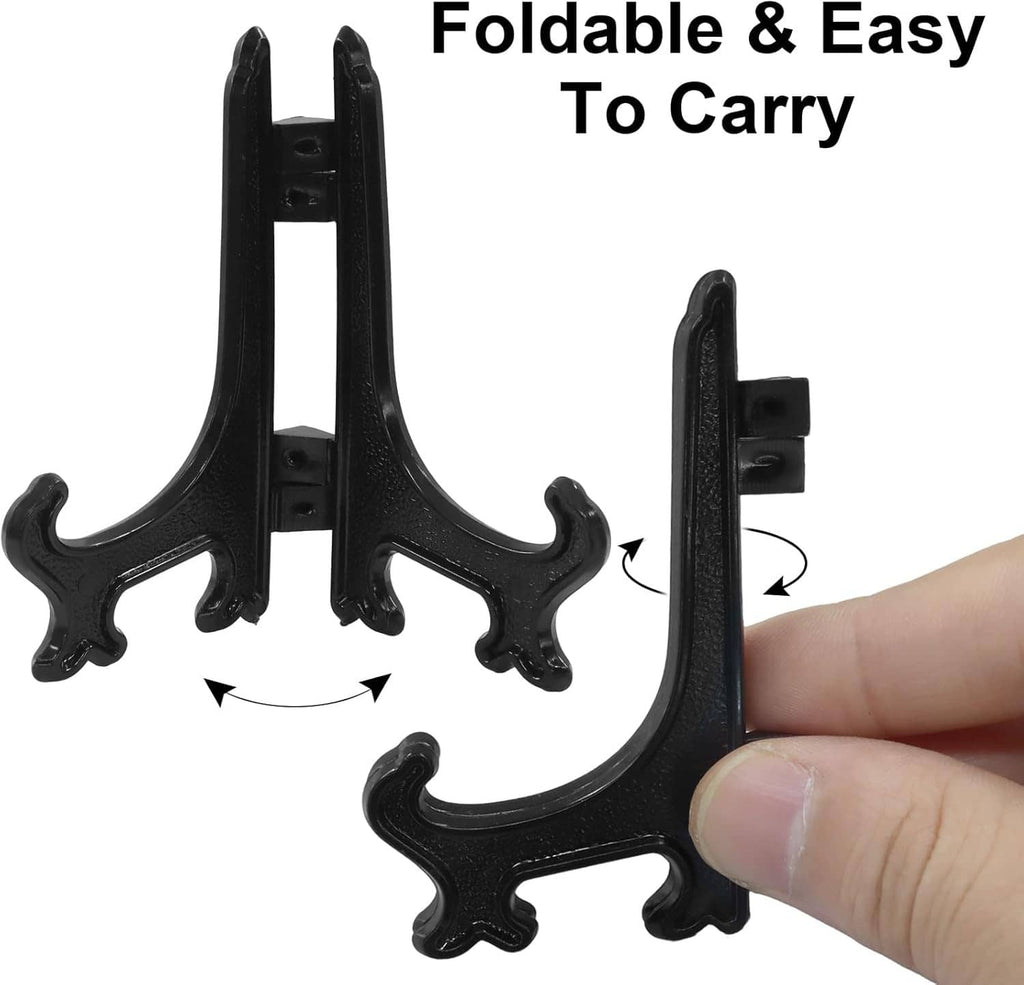 Black plastic mini easel stand with foldable legs, shown being held by a hand.
