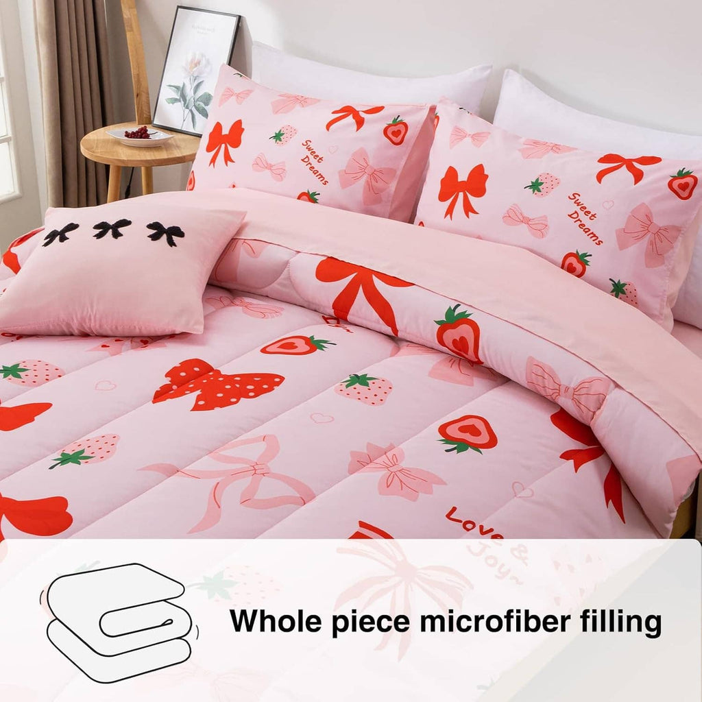 Pink comforter and pillow set with bow, strawberry, and ribbon prints