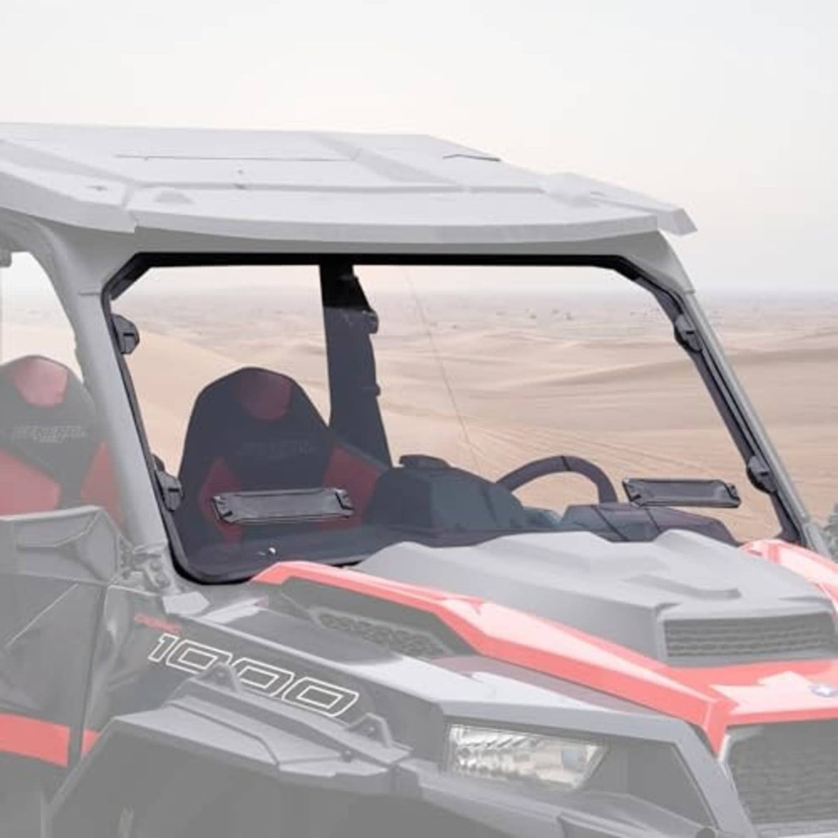 Vented full front windshield installed on off-road UTV, clear panel and black frame