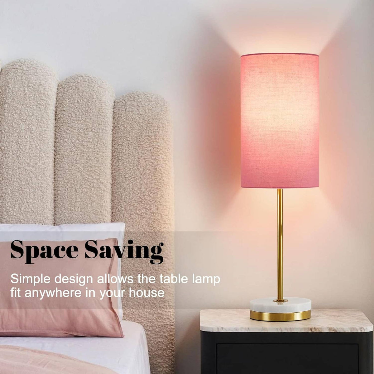 Minimalist table lamp with pink fabric shade, gold stem, and round white base.