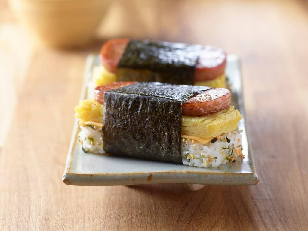 Spam Classic serving on a plate with sandwich layers and melted cheese