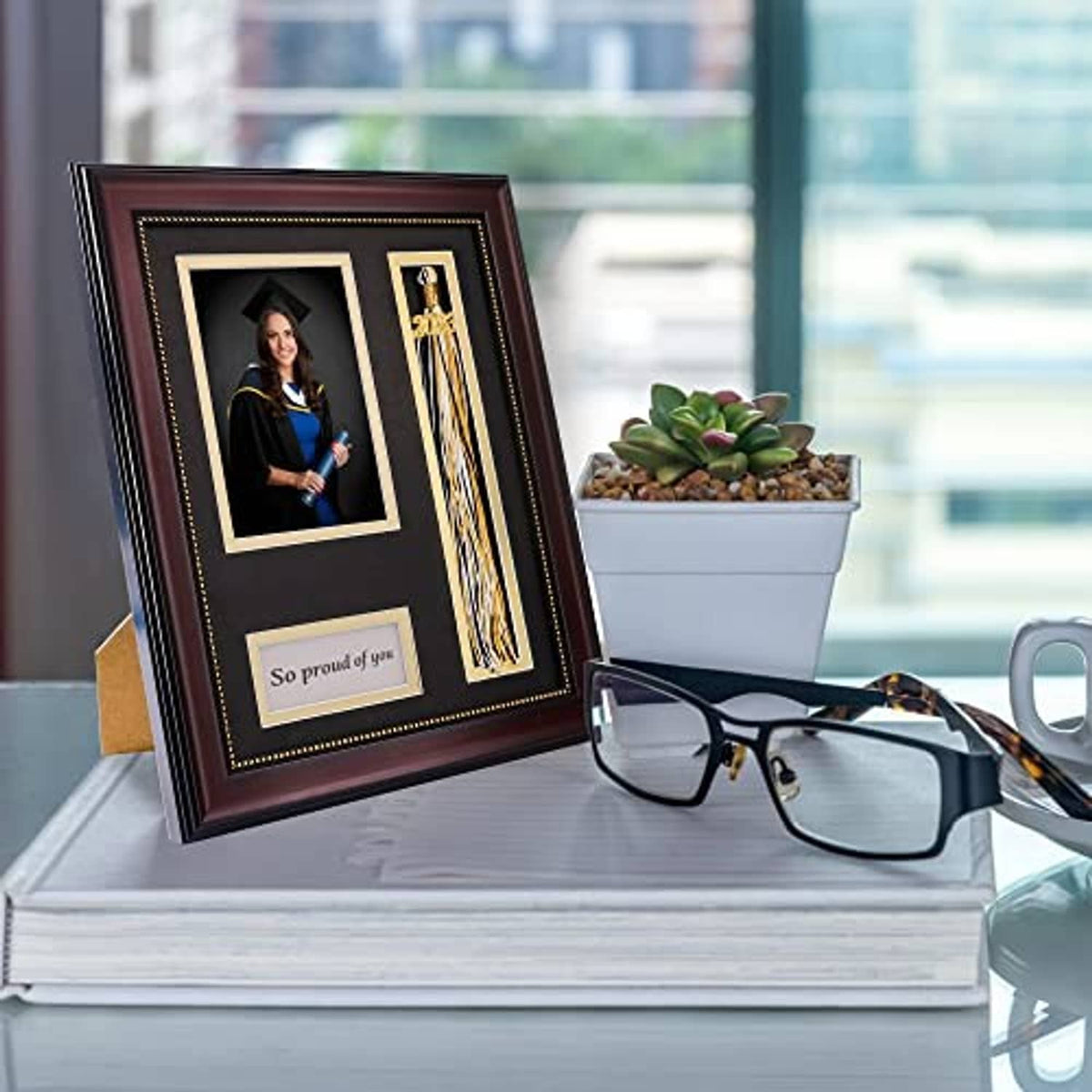 Graduation photo shadow box frame with tassel holder and two photo openings, shown in use