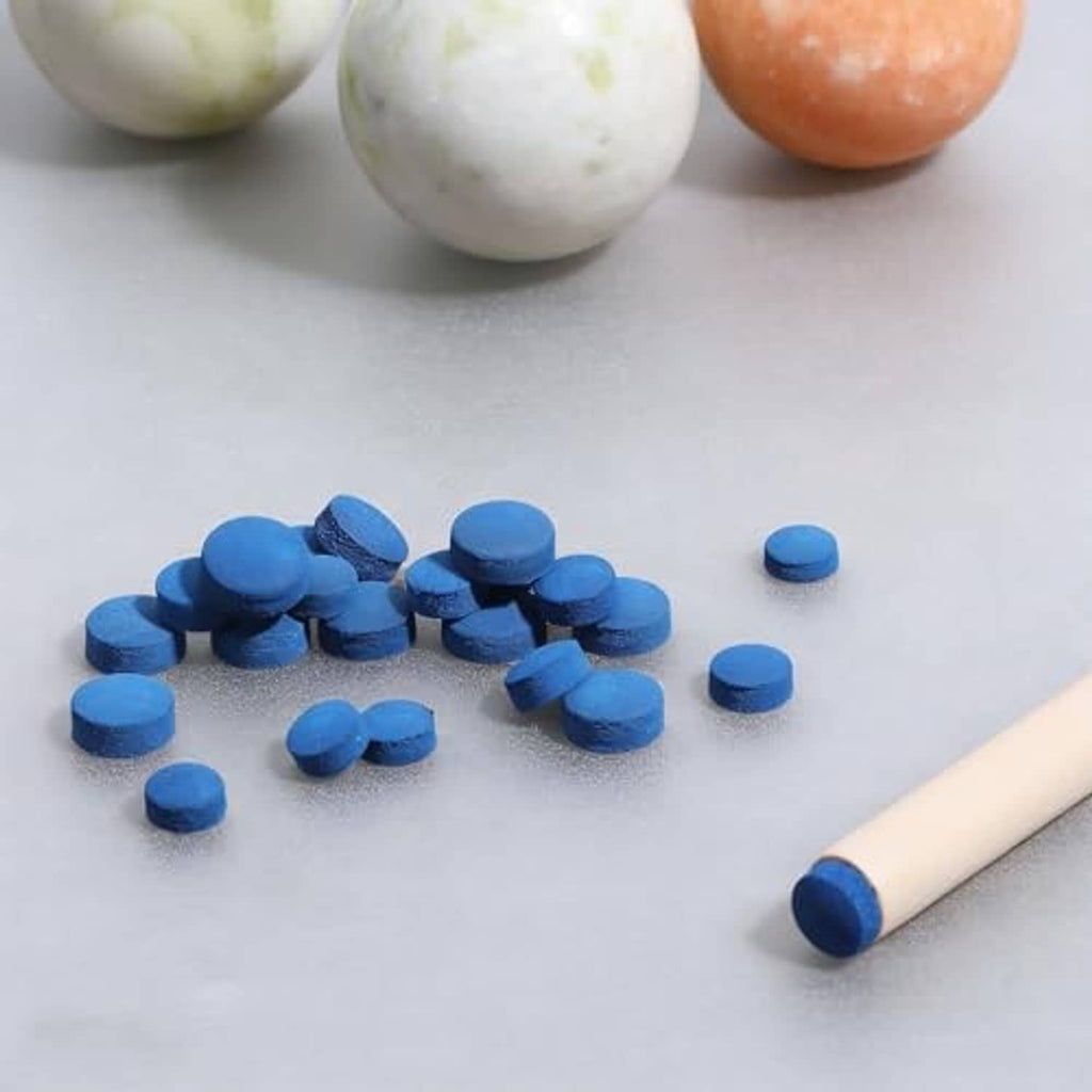 Scattered blue billiard cue tips with one tip on a cue stick
