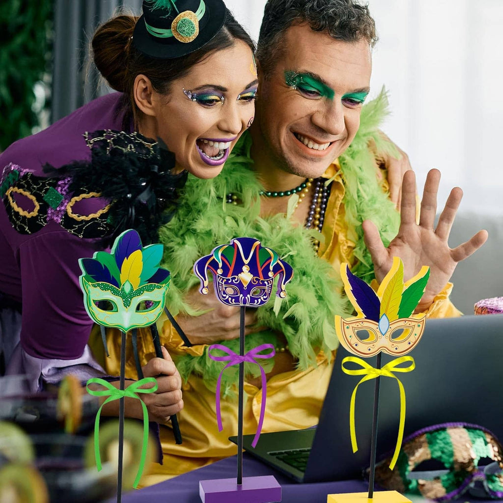Wooden Mardi Gras centerpiece set with three mask toppers on stick stands with ribbon bows