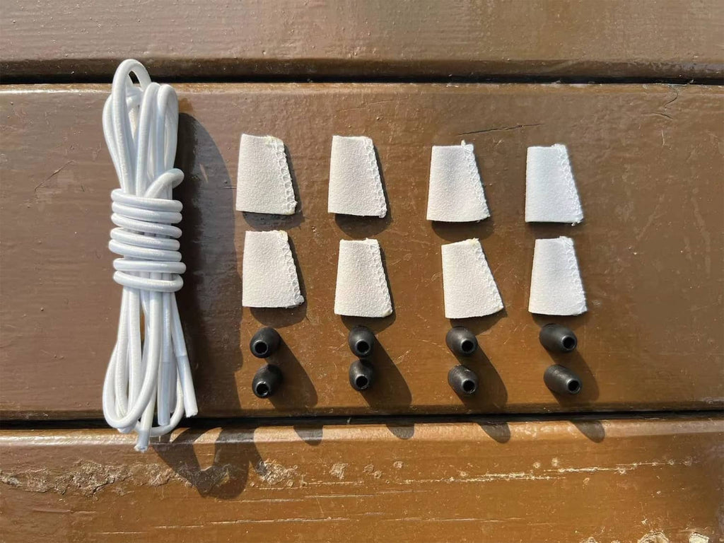 White elastic shoelaces with fabric end caps and rubber grommet anchors