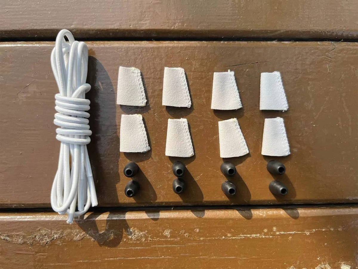White elastic shoelaces with fabric end caps and rubber grommet anchors