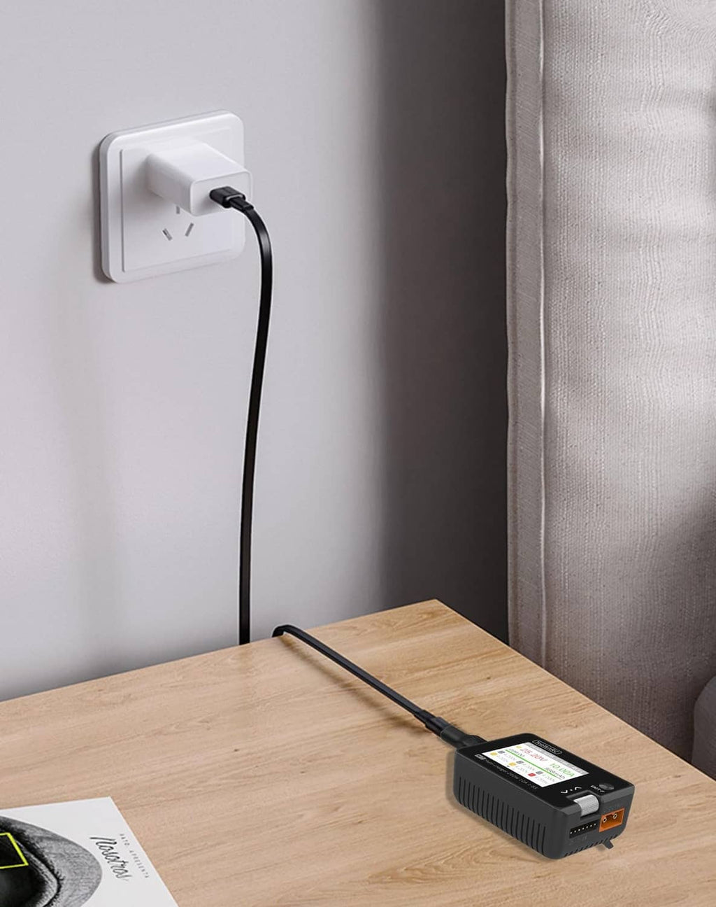 Black USB-C to XT30 adapter with cable plugged into an outlet