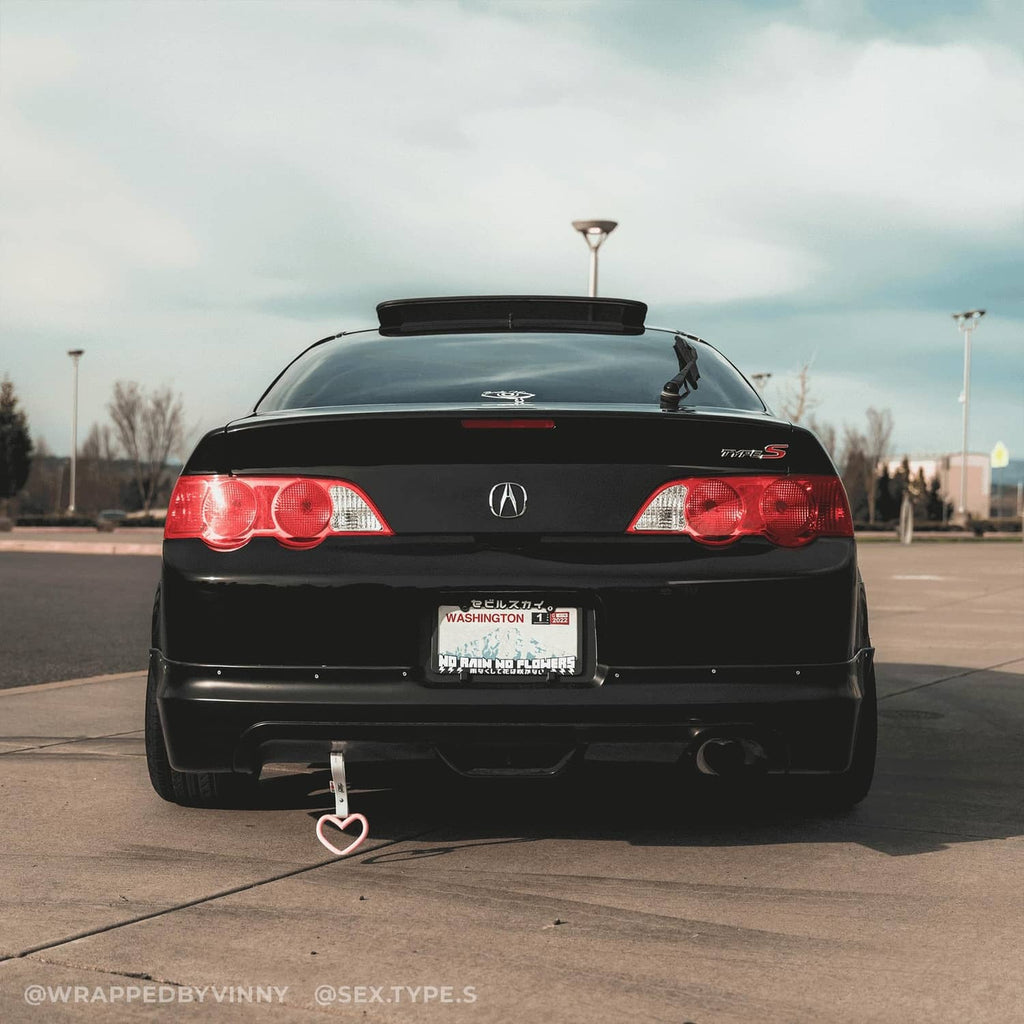 Black high-gloss vinyl-wrapped car rear bumper and trunk, realistic paint-like finish