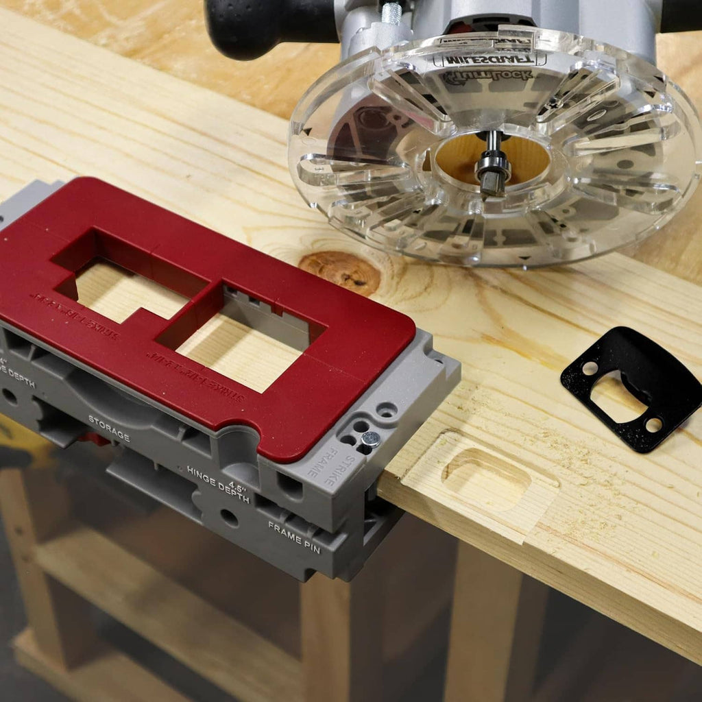 Door hinge mortising jig with red guide plate on wood, with clear router above