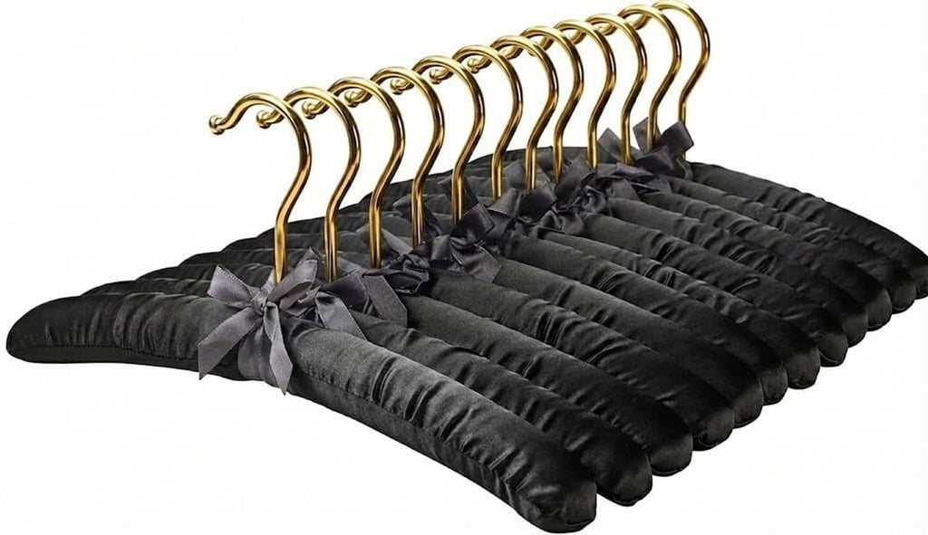 Set of 12 black padded fabric hangers with gold hooks and shoulder bows