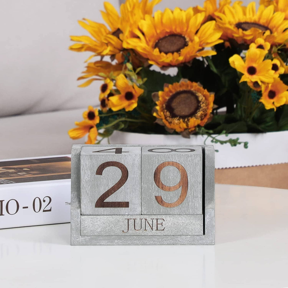 Grey desk calendar blocks showing 2 and 9 with JUNE label