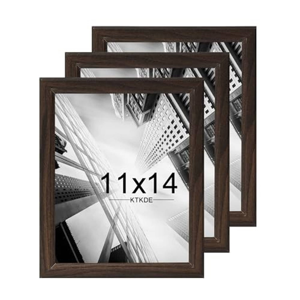 Three overlapping walnut woodgrain frames for 11x14 photos, dark brown rectangular openings
