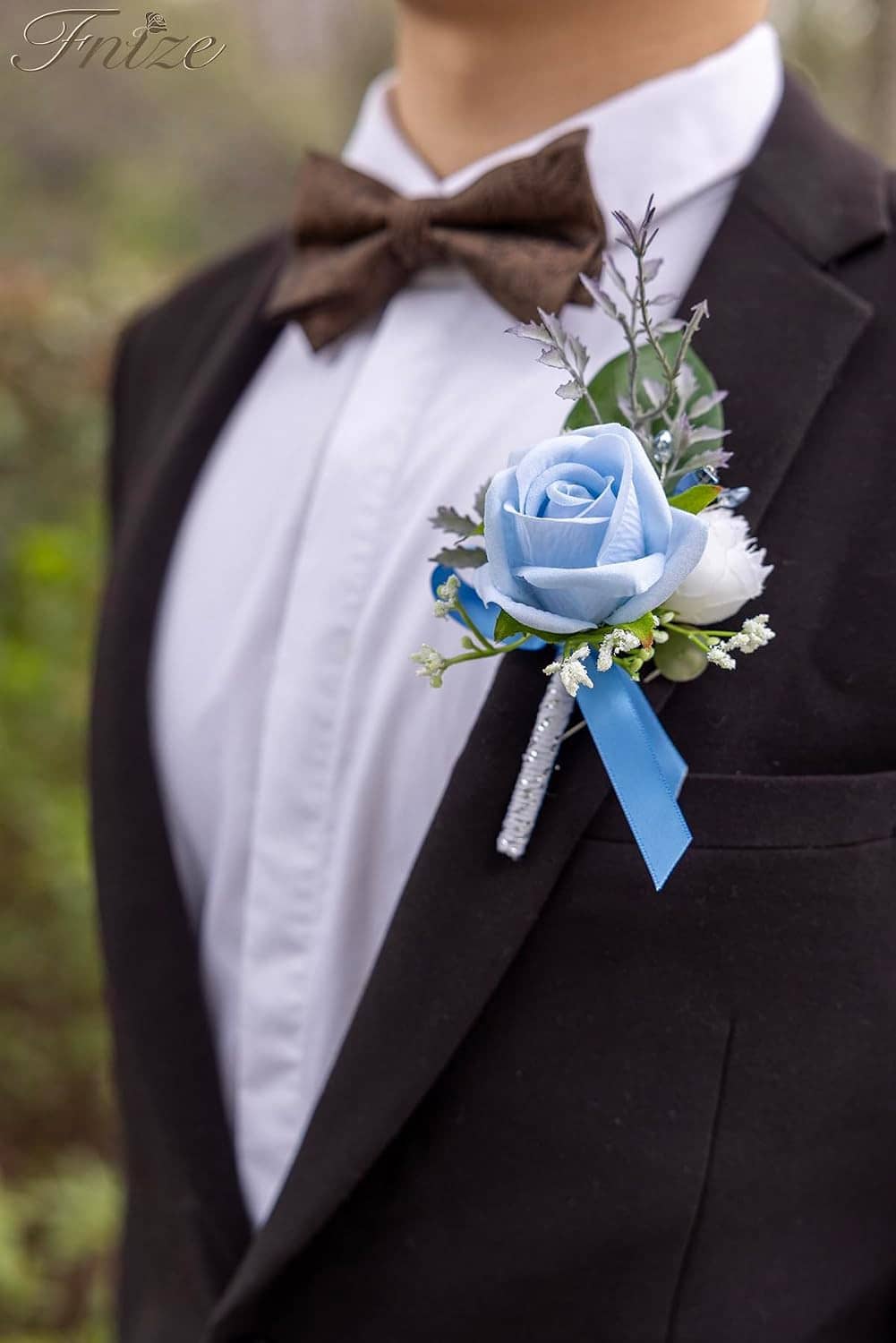 Blue rose boutonniere on a dark suit lapel with white accents and blue ribbon