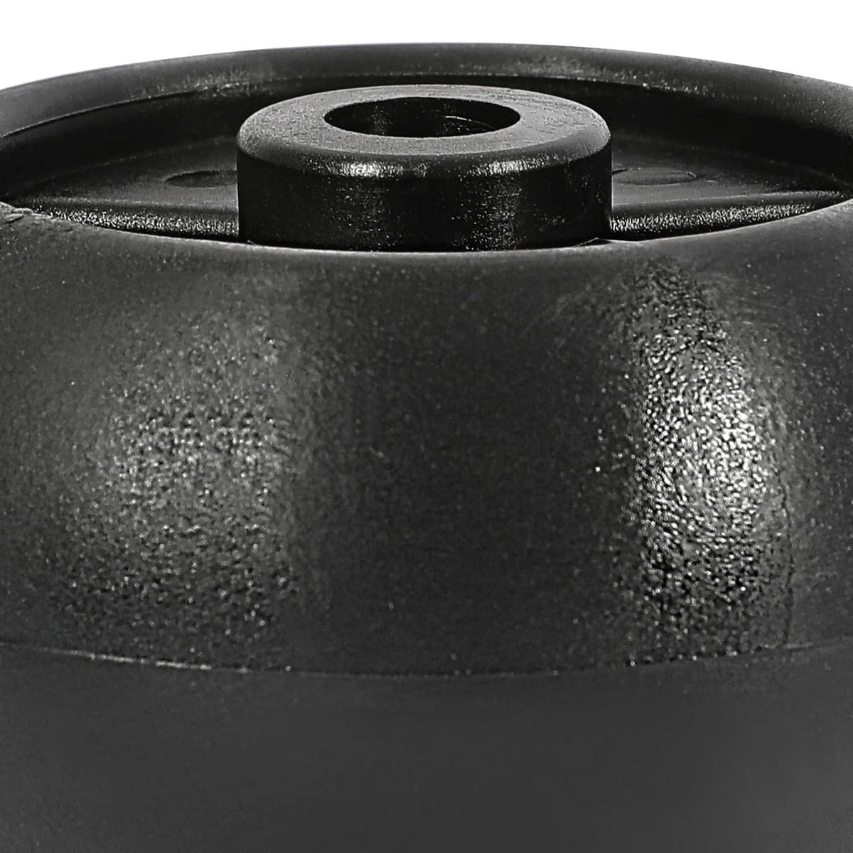 Close-up of black wheel top with circular mounting opening in raised hub