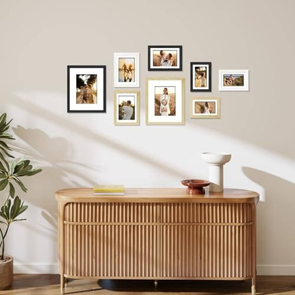 Wall display of multiple black and tan photo frames with real-glass fronts