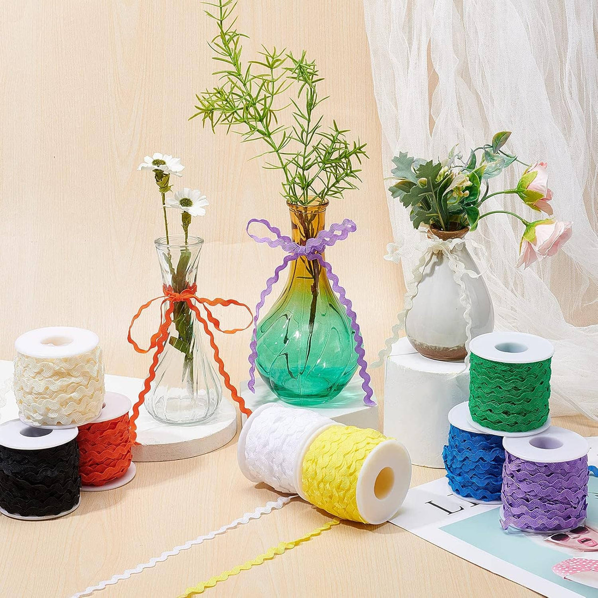 Assorted wave sewing ribbon trims on spools, with wavy fringe edges.