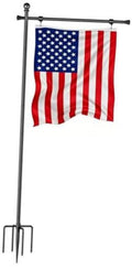 In-ground flag pole holder with adjustable crossbar and American flag on dark pole