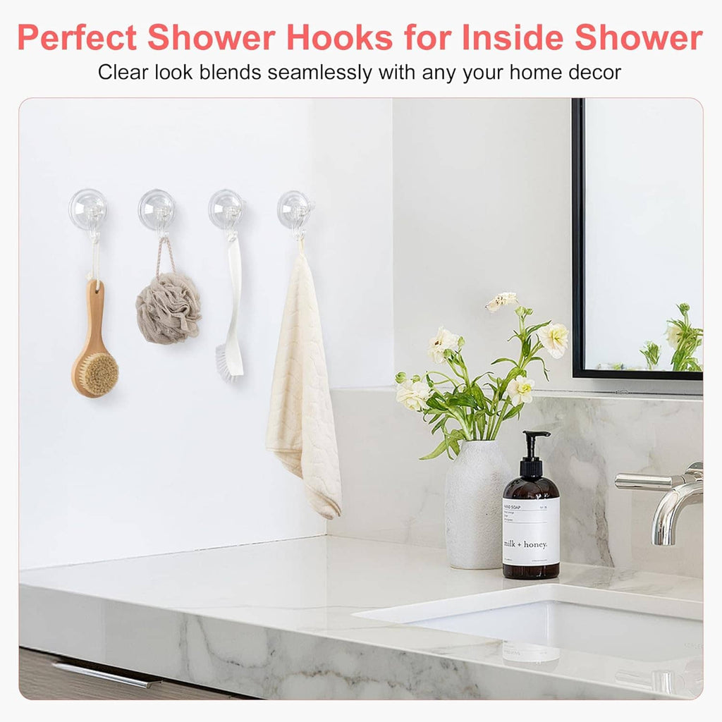Transparent suction cup shower hooks holding towel and bath items inside shower