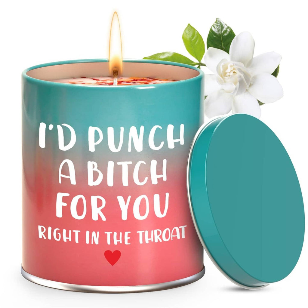 Scented candle with teal lid, pink wax and white floral topper