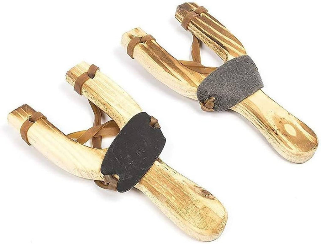 Two wooden slingshots, natural finish, with black bands and tan leather straps, side view