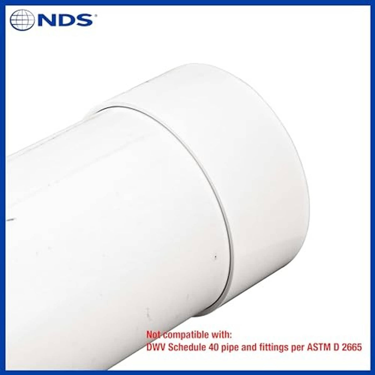 White 6-inch PVC S&D end cap on pipe stub, close-up angle