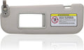 Gray driver-side sun visor with vanity mirror panel and mounting clip