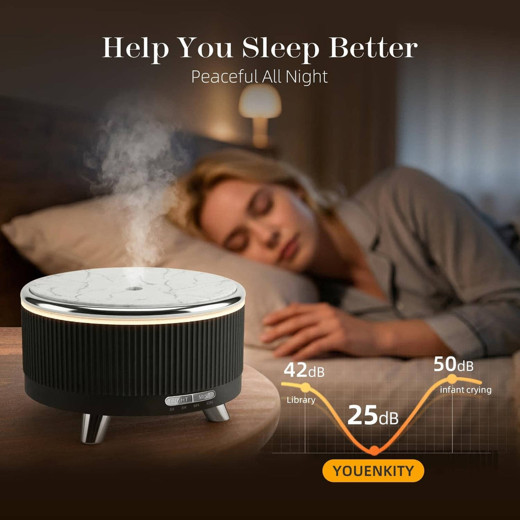 Black ultrasonic essential oil diffuser releasing visible mist with round marble-look top
