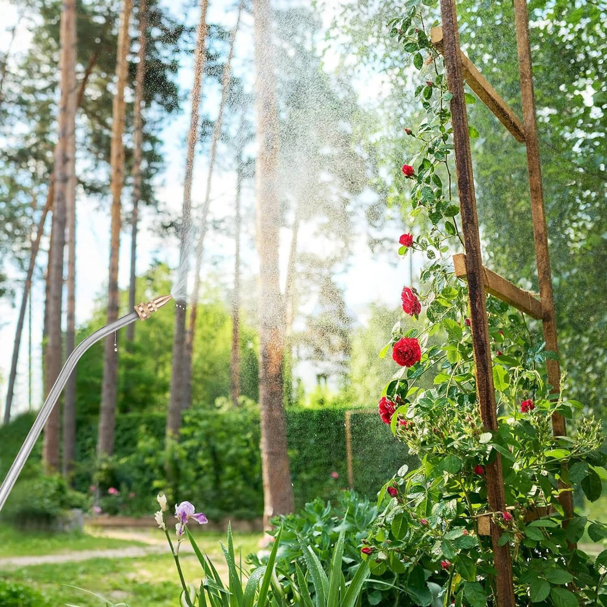 Brass adjustable spray nozzle misting plants from a garden sprayer wand