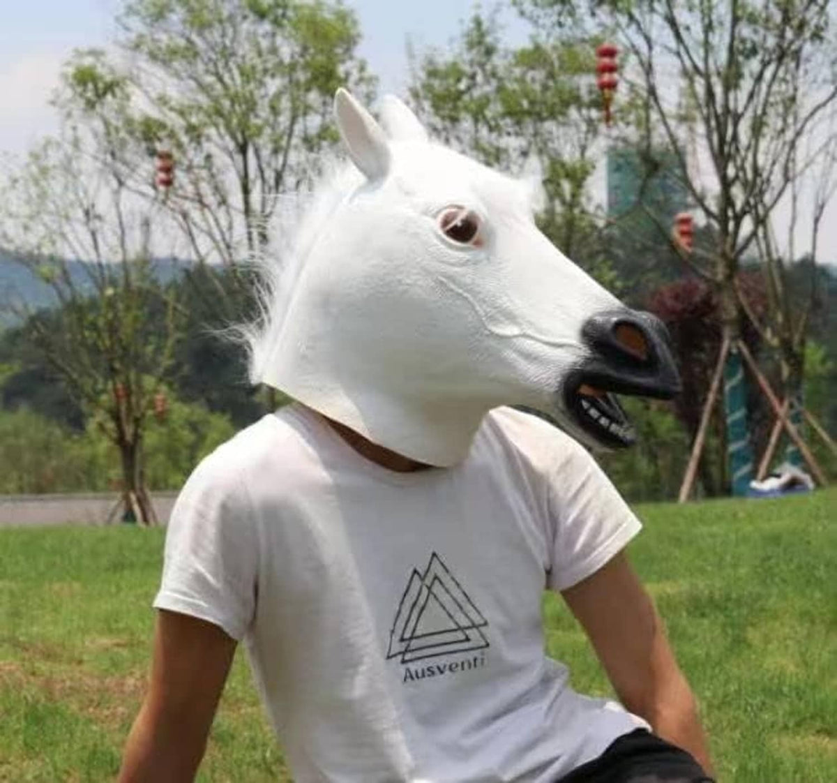 White horse latex head mask worn on head; brown eyes, black muzzle, white teeth