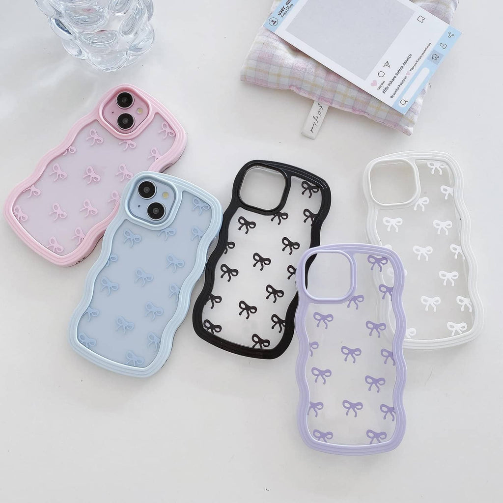 Pink clear iPhone case with bow pattern among other ribbon-decorated cases.