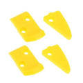 Yellow plastic tire changer mount/demount head inserts, four pieces laid out